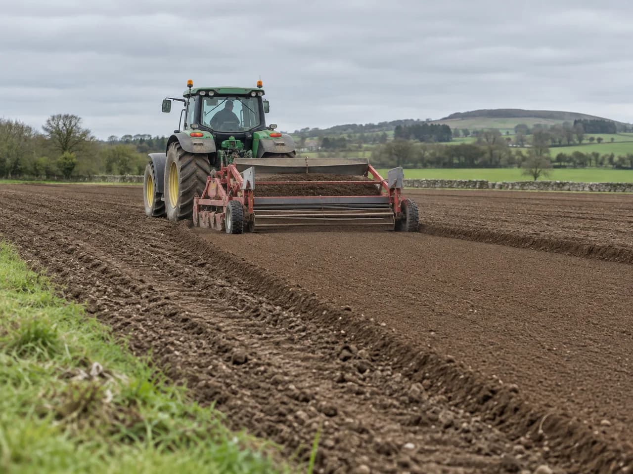 Illustration of machinery preparing and forming a carrot seedbed.